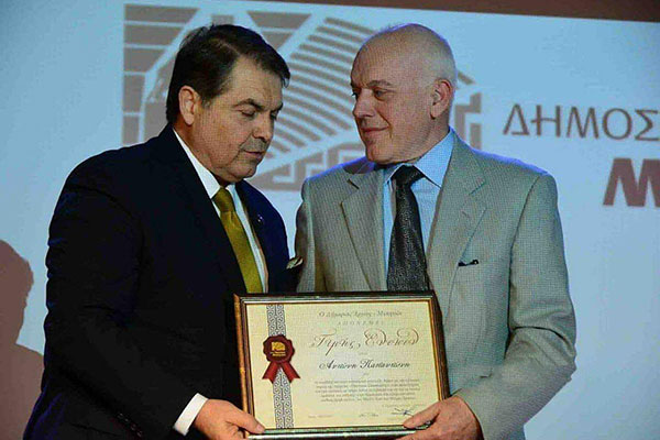 Receiving an award from the mayor of Argos city